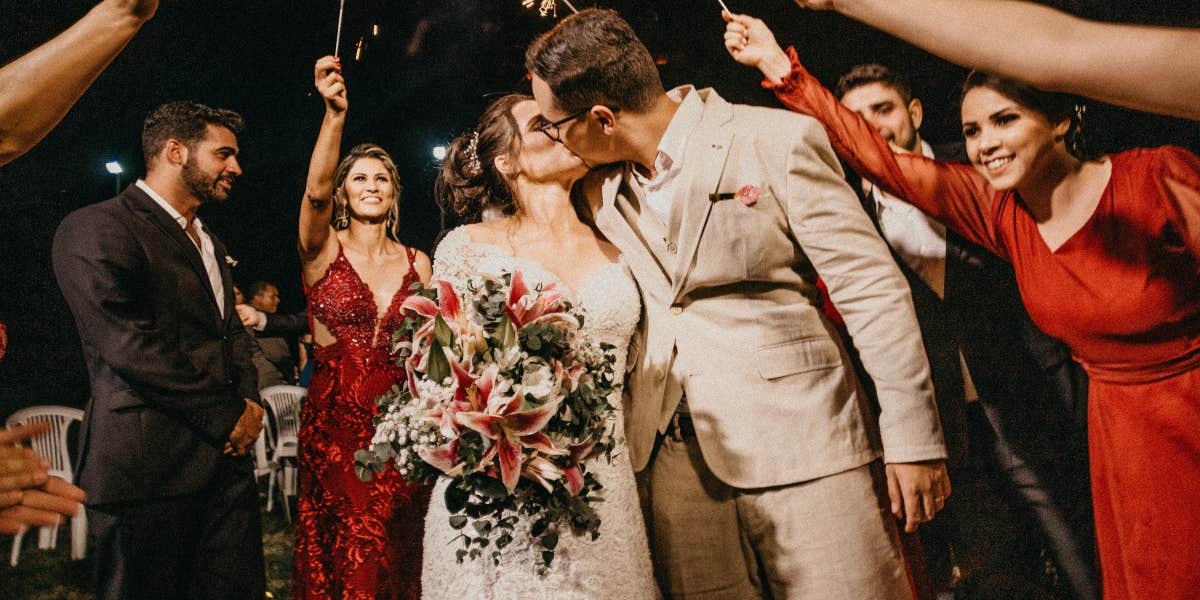 Bride and groom kissing at wedding reception