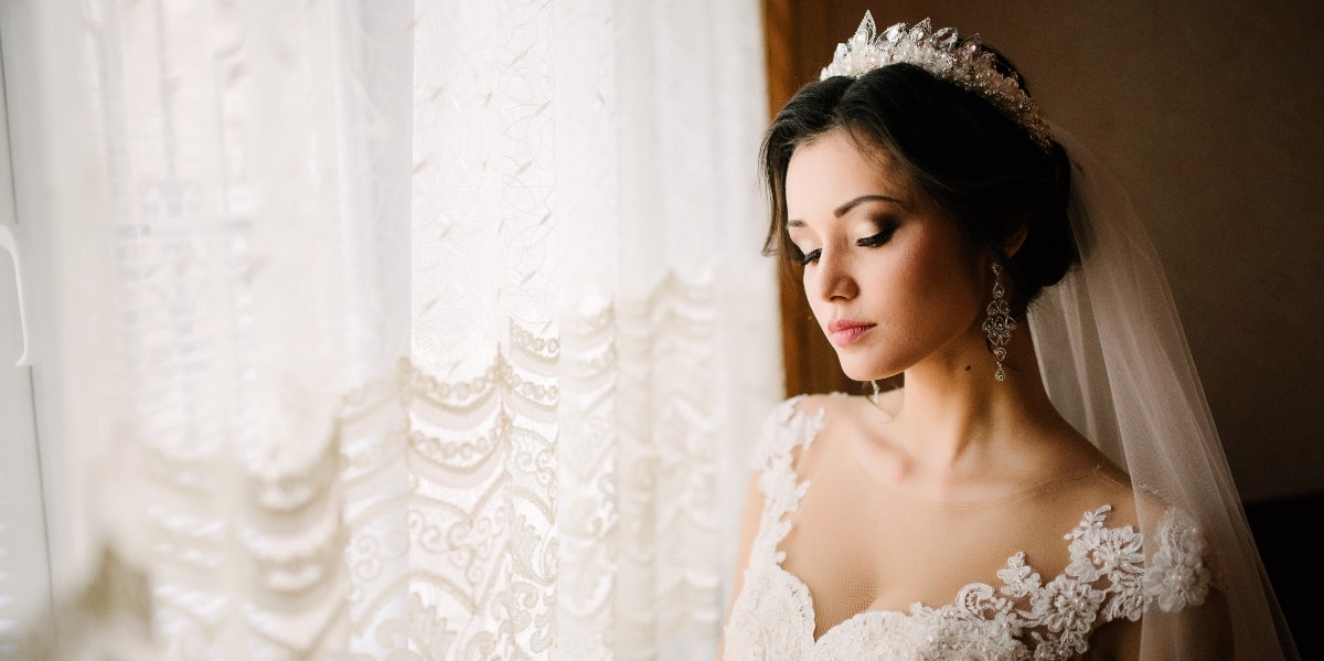 bride posing in front of window