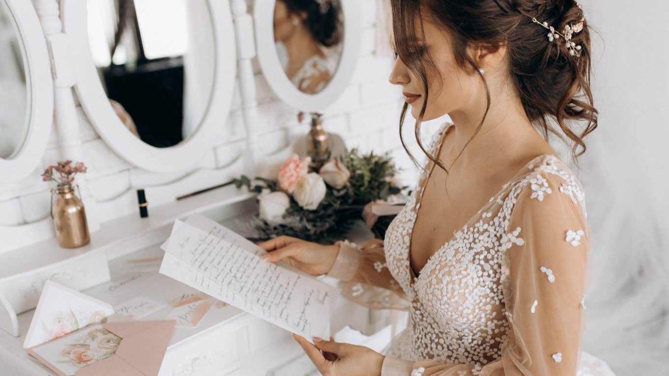 bride opening letter on her wedding day
