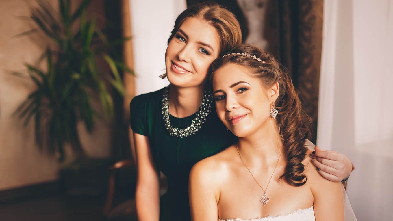 bride and sister smiling