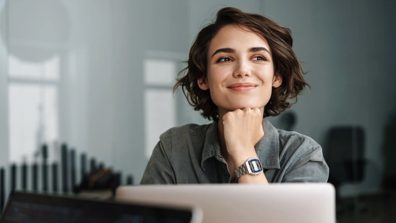 successful woman smiles while she completes her work efficiently