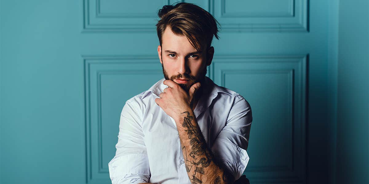 man posing with beard and tattoos