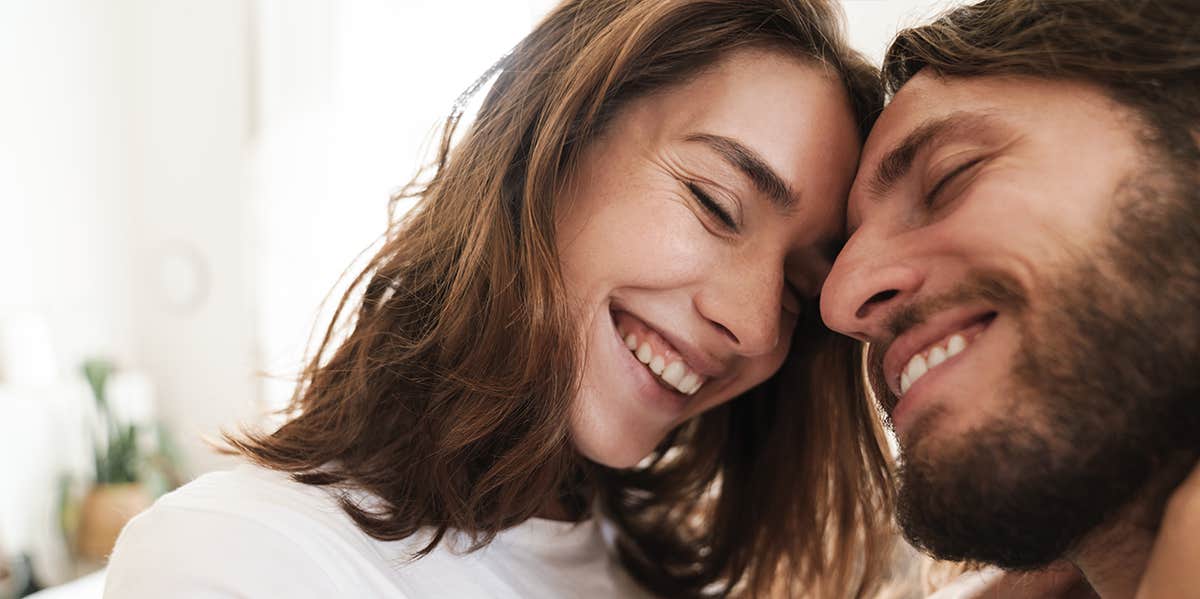 man and woman nuzzling foreheads