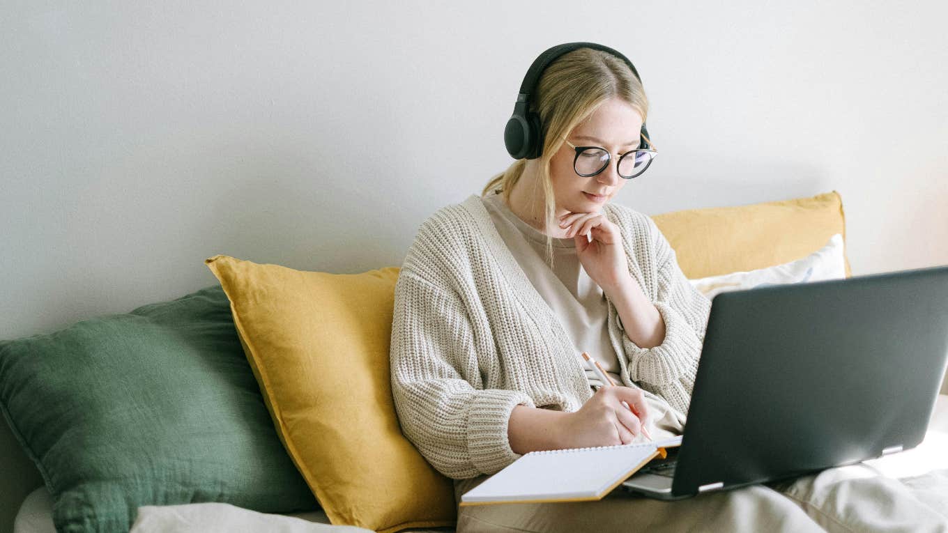 woman on couch working on laptop