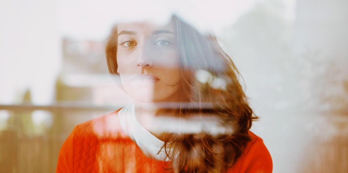 woman in red looking burned out and tired