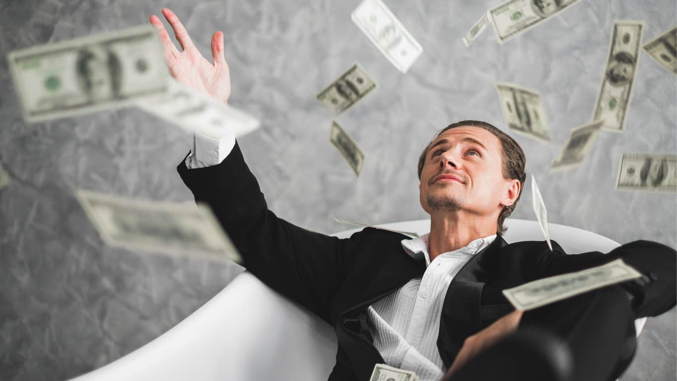Business Guru Says People Struggling Should Just Make $10k More A Year Man throwing money in the air