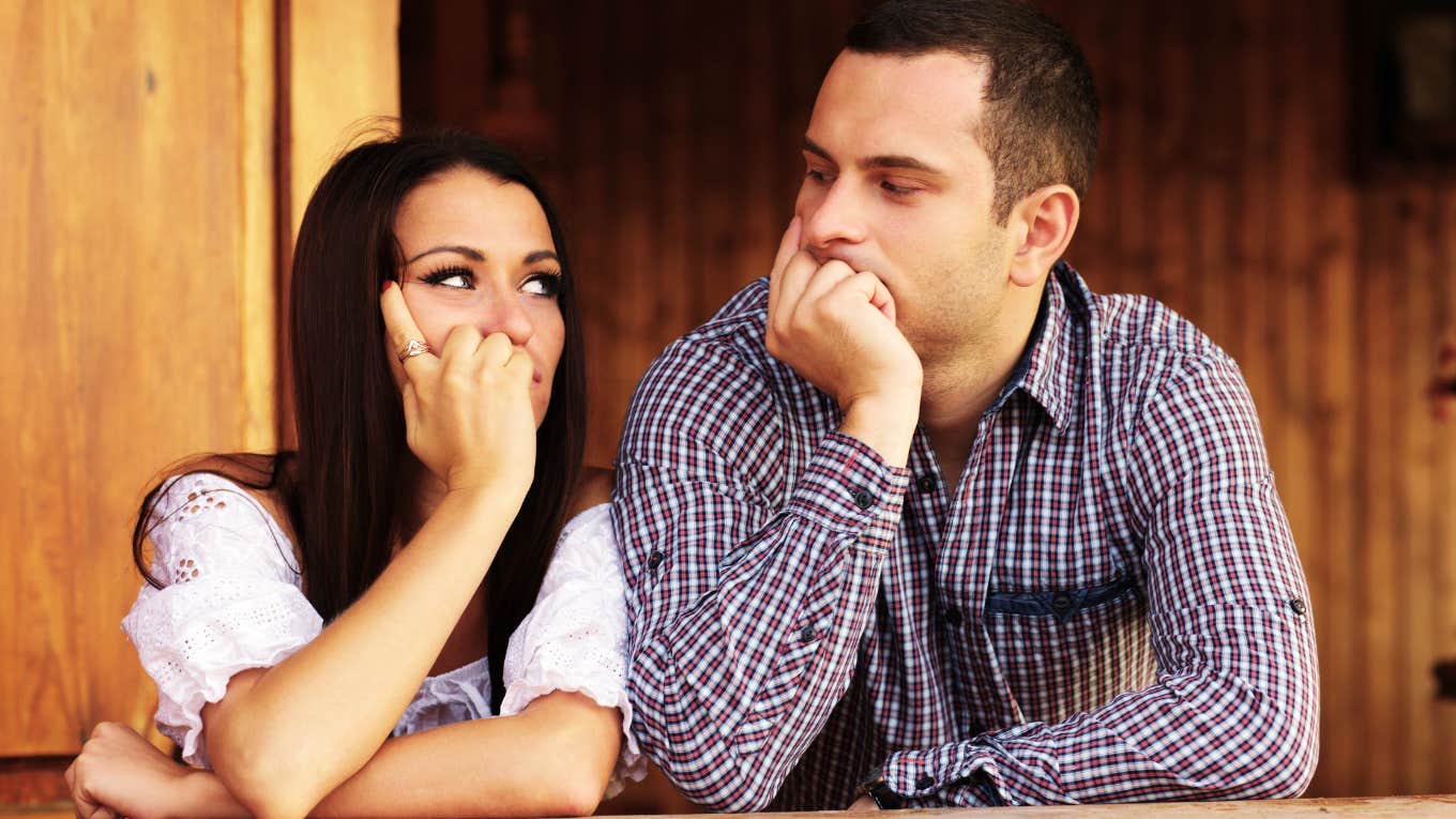 couple looking at each other during a fight trying to stay calm