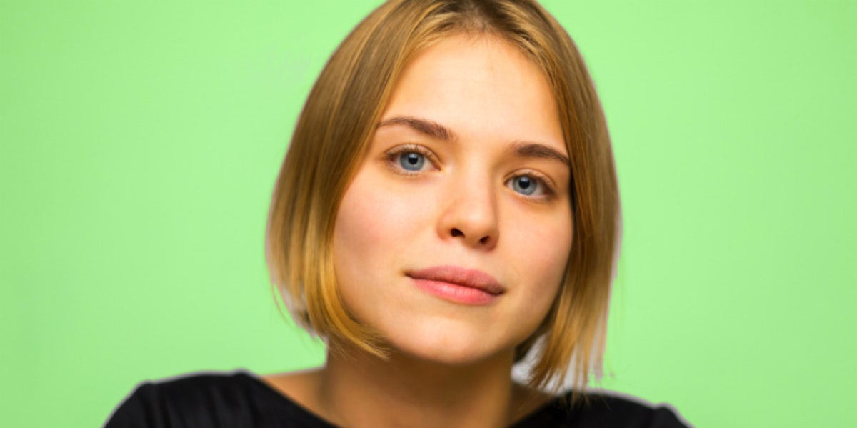 woman staring green background