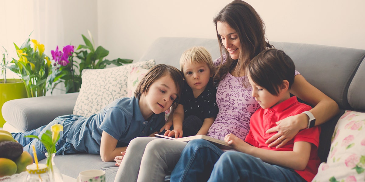 mom reading book to kids