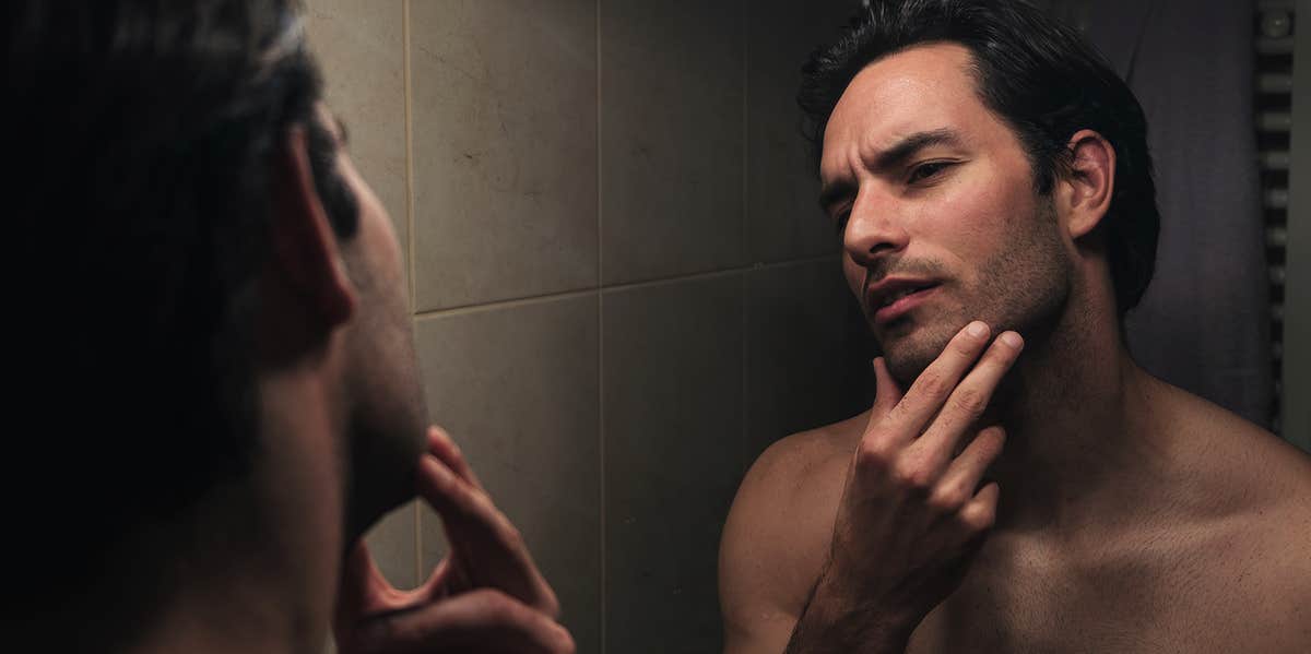 man looking in mirror