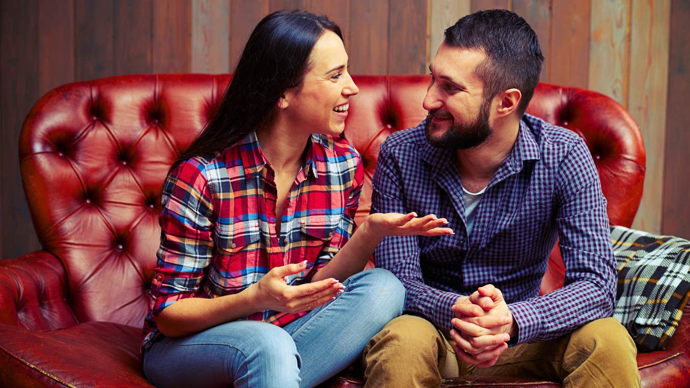 couple sitting on couch talking