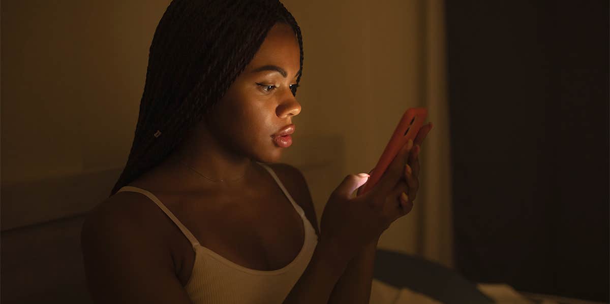 woman texting at night