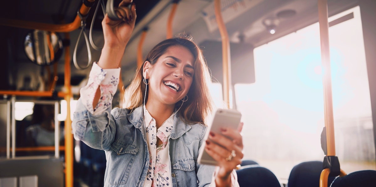 woman on her phone in the bus