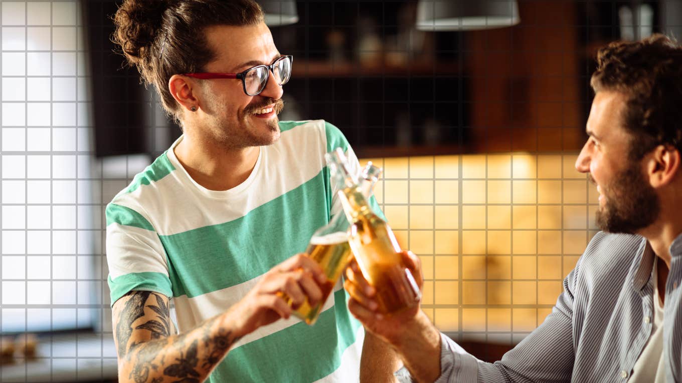 Men tapping a beer, laughing