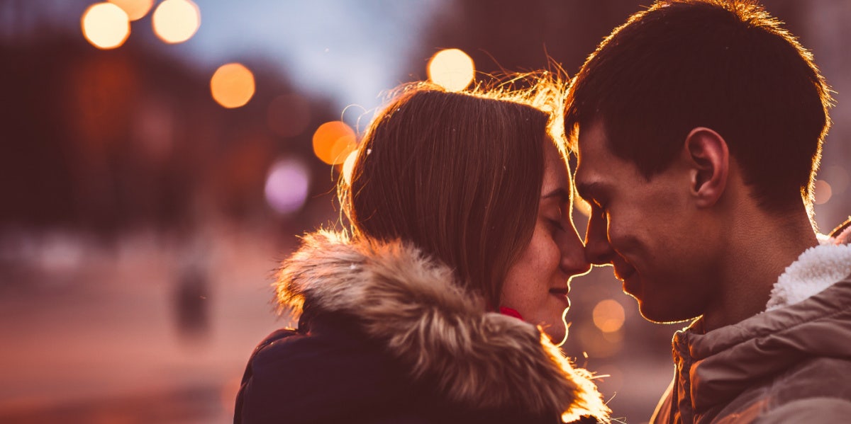 couple smiling heads touching outside