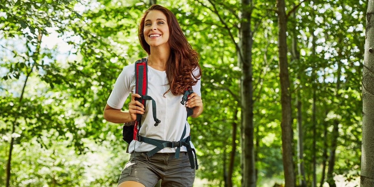 older woman hiking in the forest