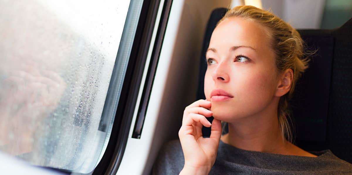 Pensive woman on a bus looks out window