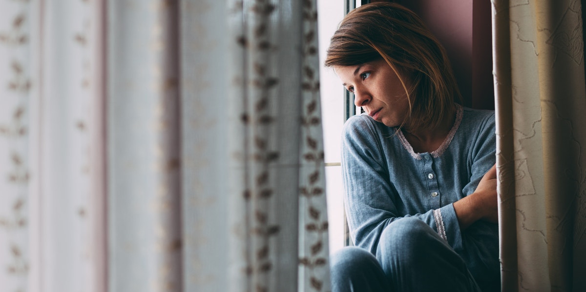 sad woman looking out a window