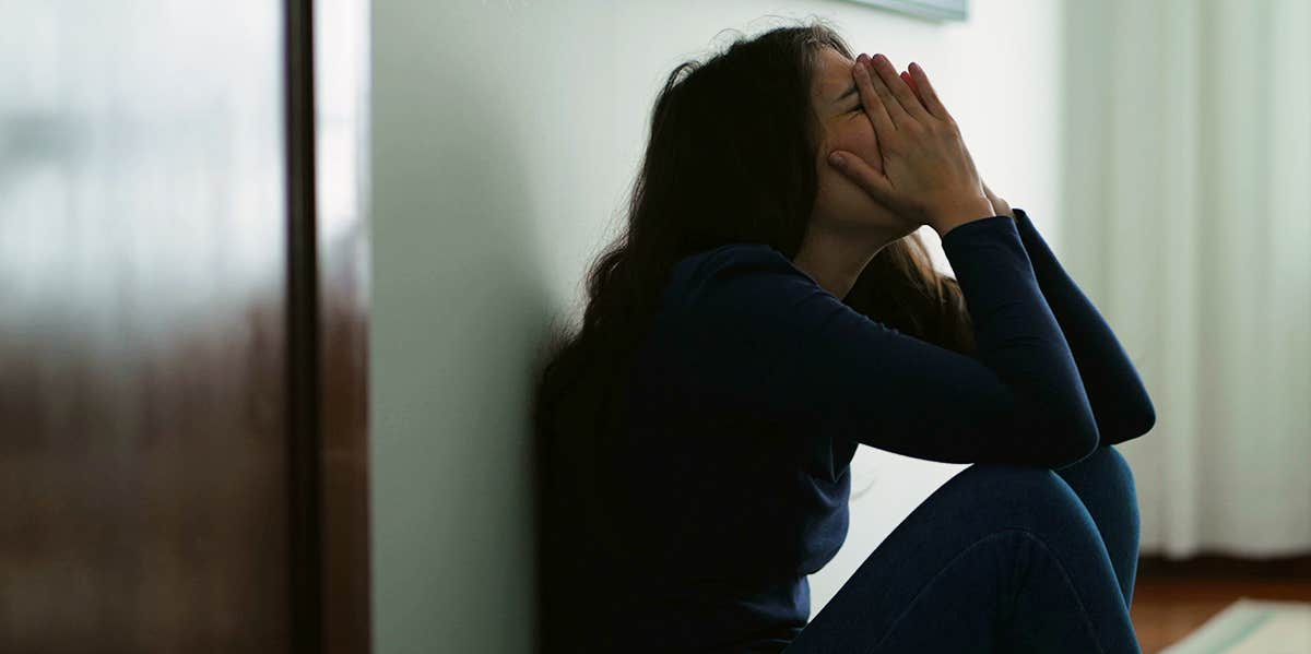 stressed woman sitting on ground