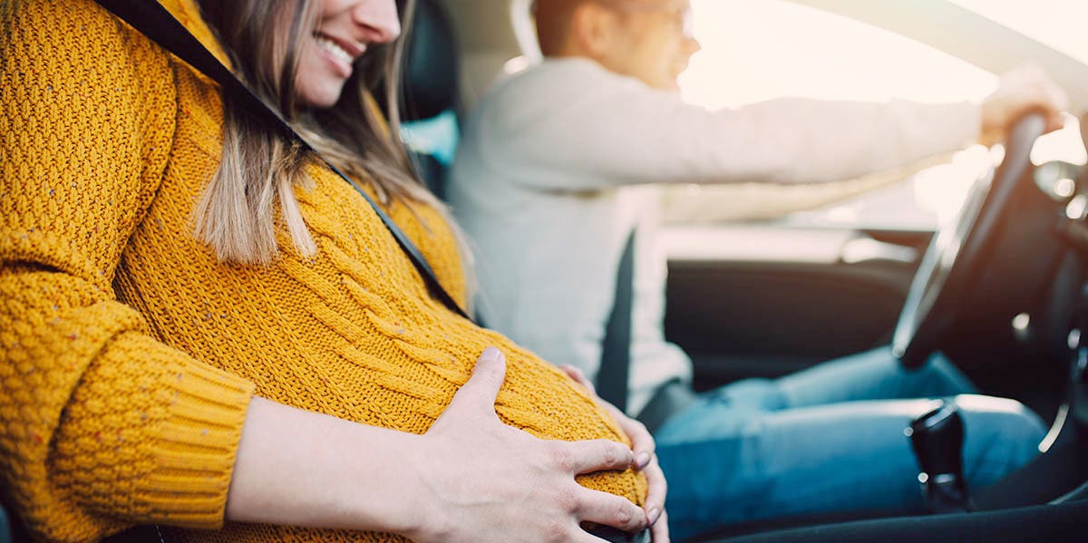 woman in labor in car