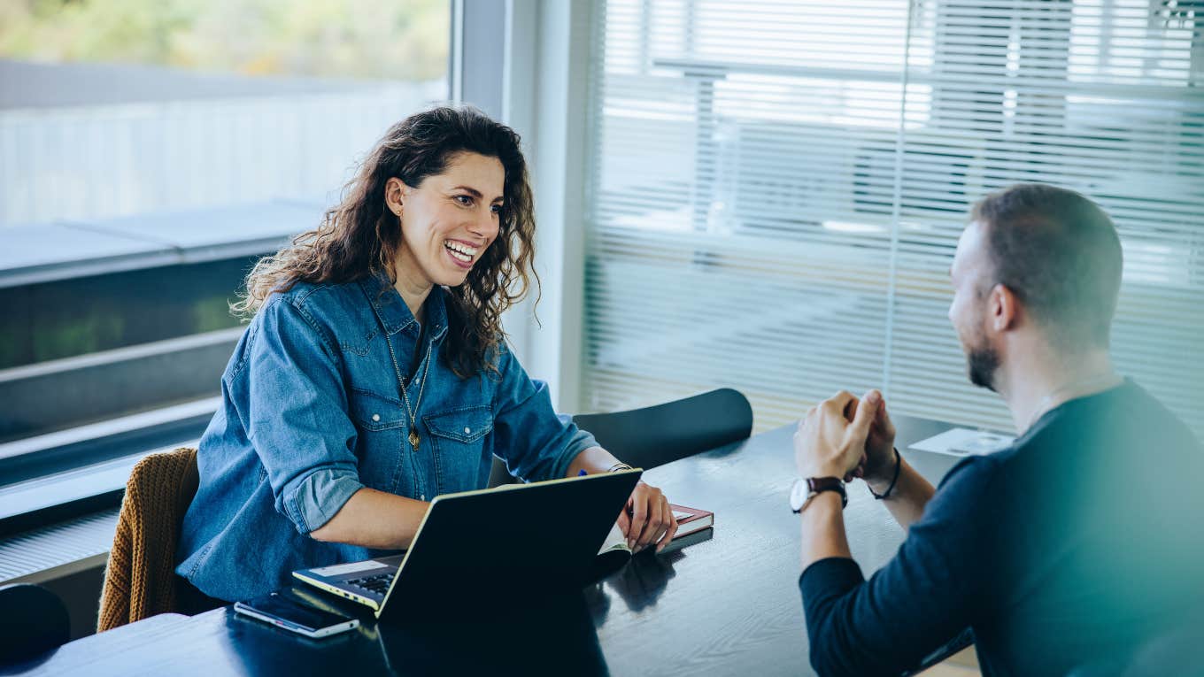 Smiling businesswoman taking interview of a job applicant