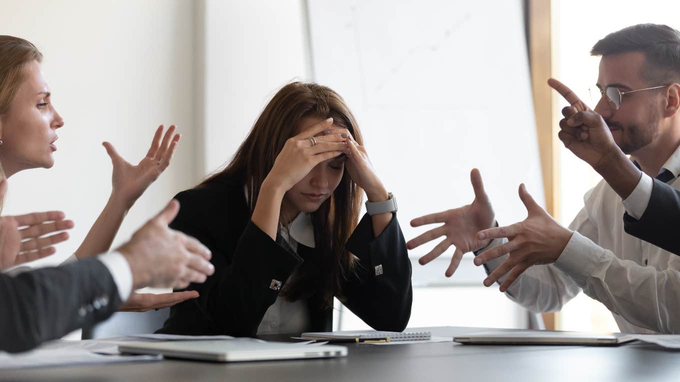 woman struggling in office, workplace trauma