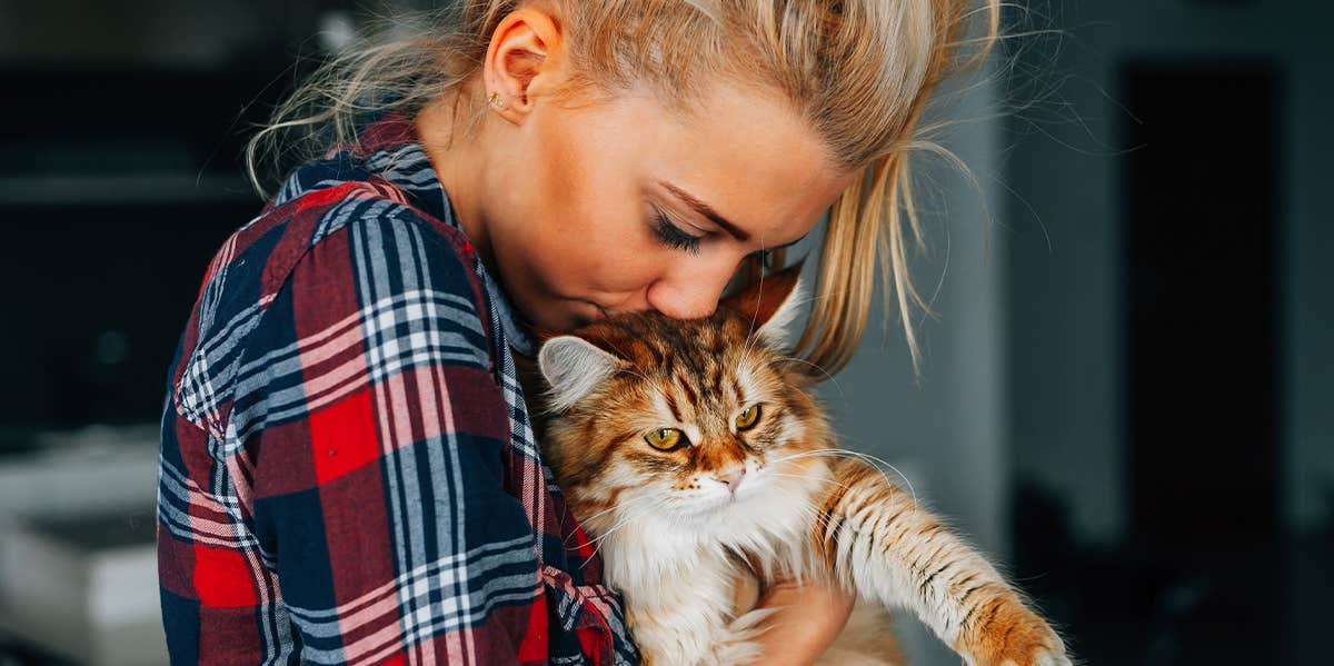 girl kissing her cat