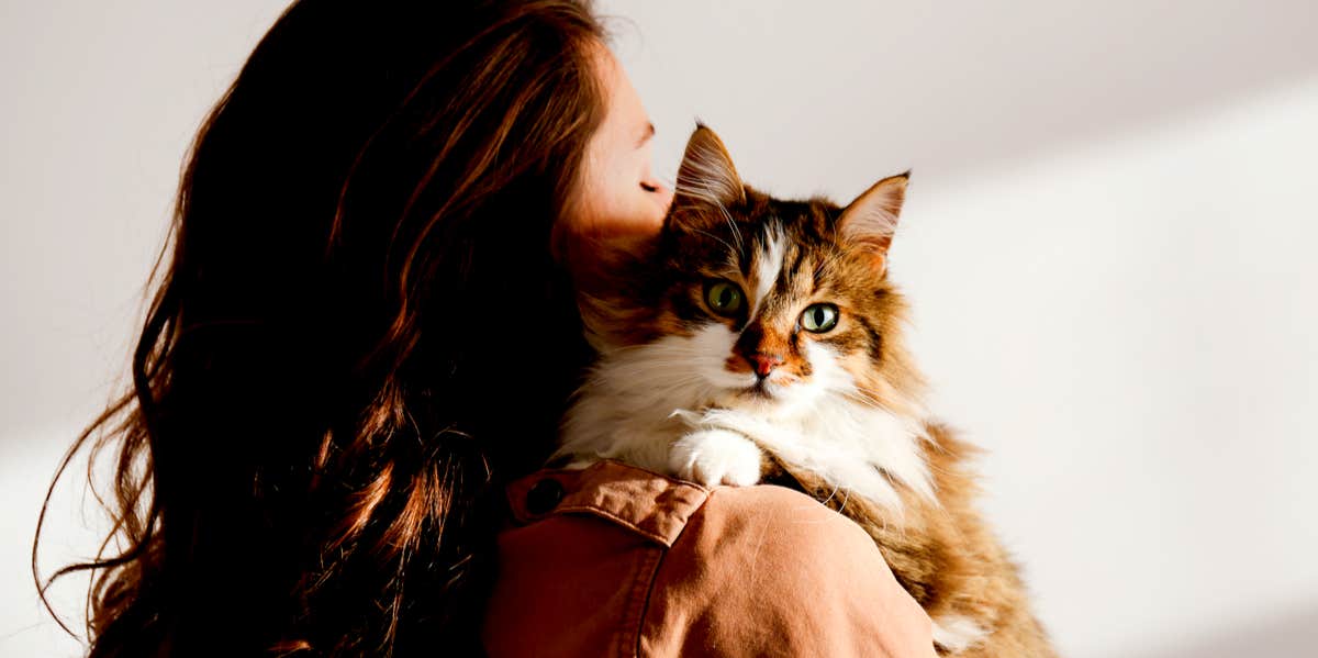 woman holding cat