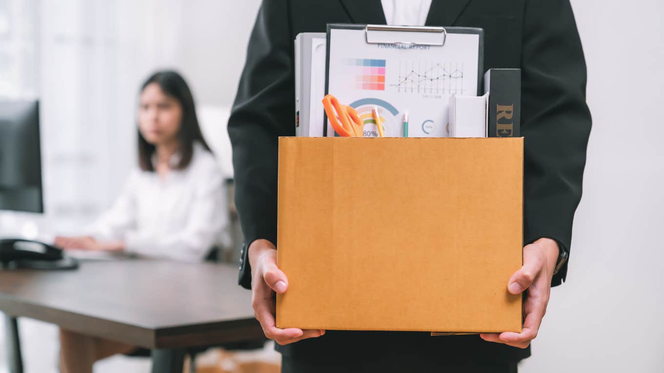 employee leaving work with box of things after being fired