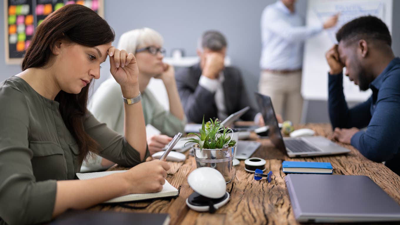 annoyed woman in a useless meeting