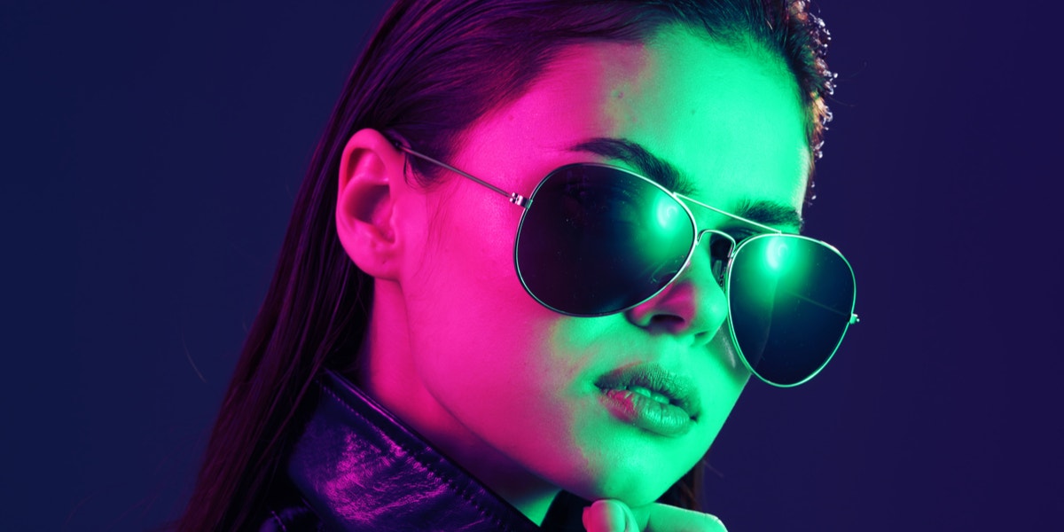 woman in sunglasses in green and pink 