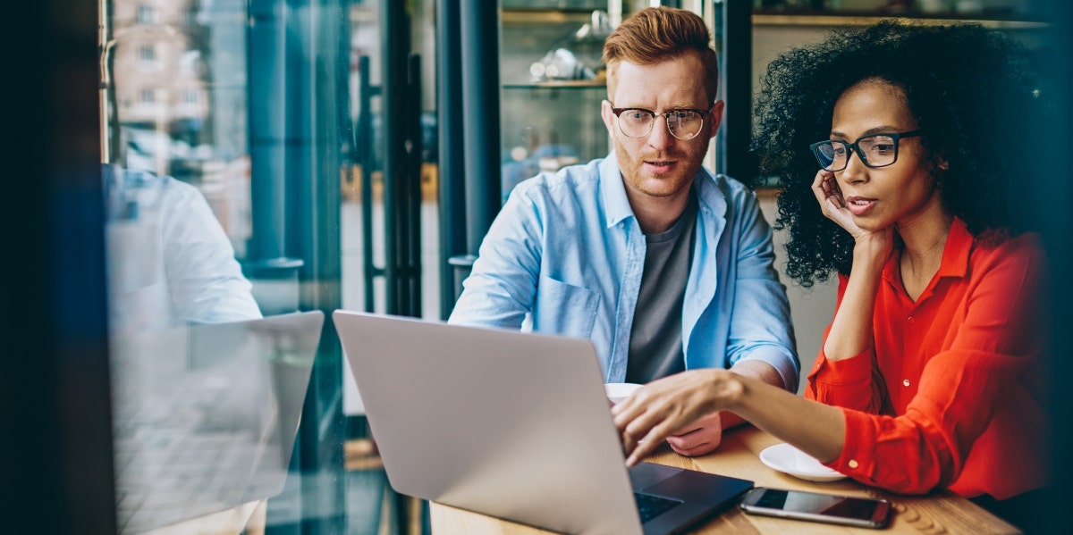 office man and woman looking at laptop