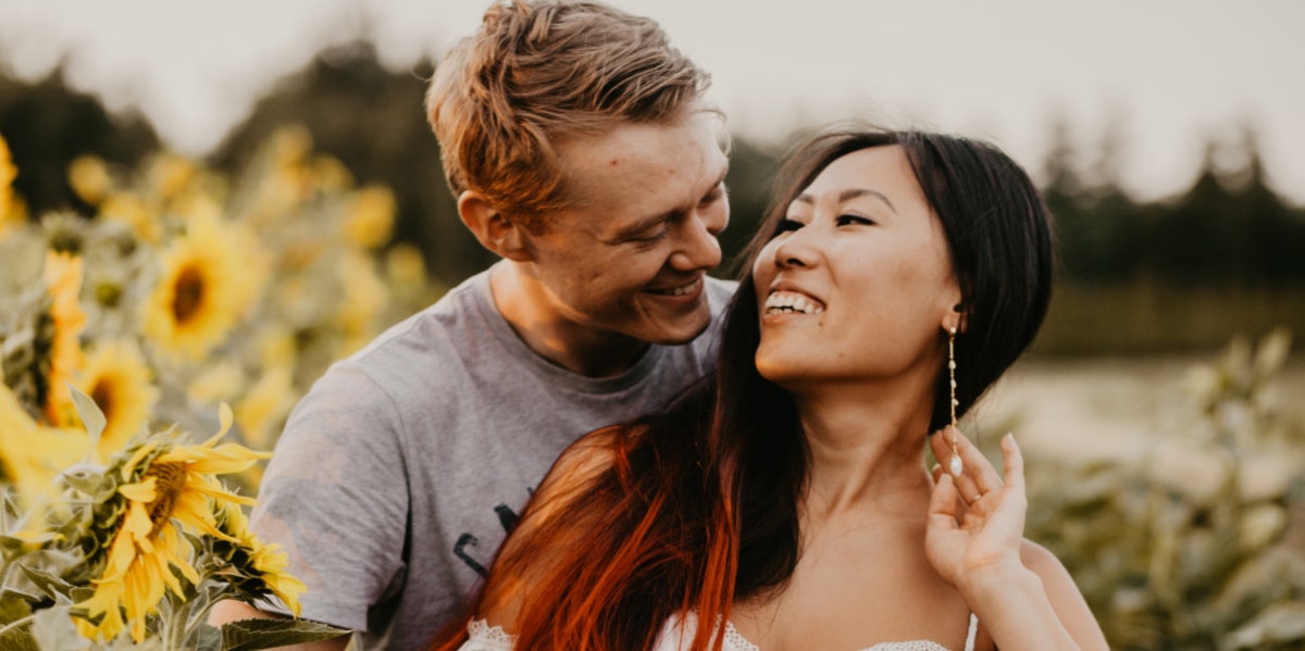 man and woman in flower field 