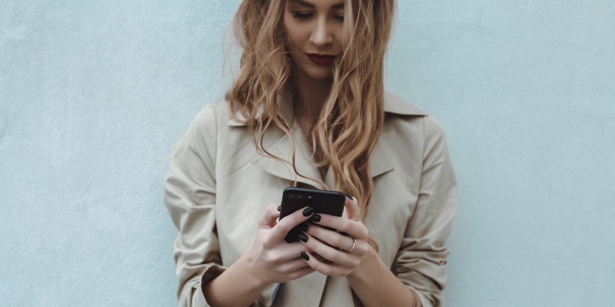 I Changed My Facebook Relationship Status And Sh*t Hit The Fan woman using phone