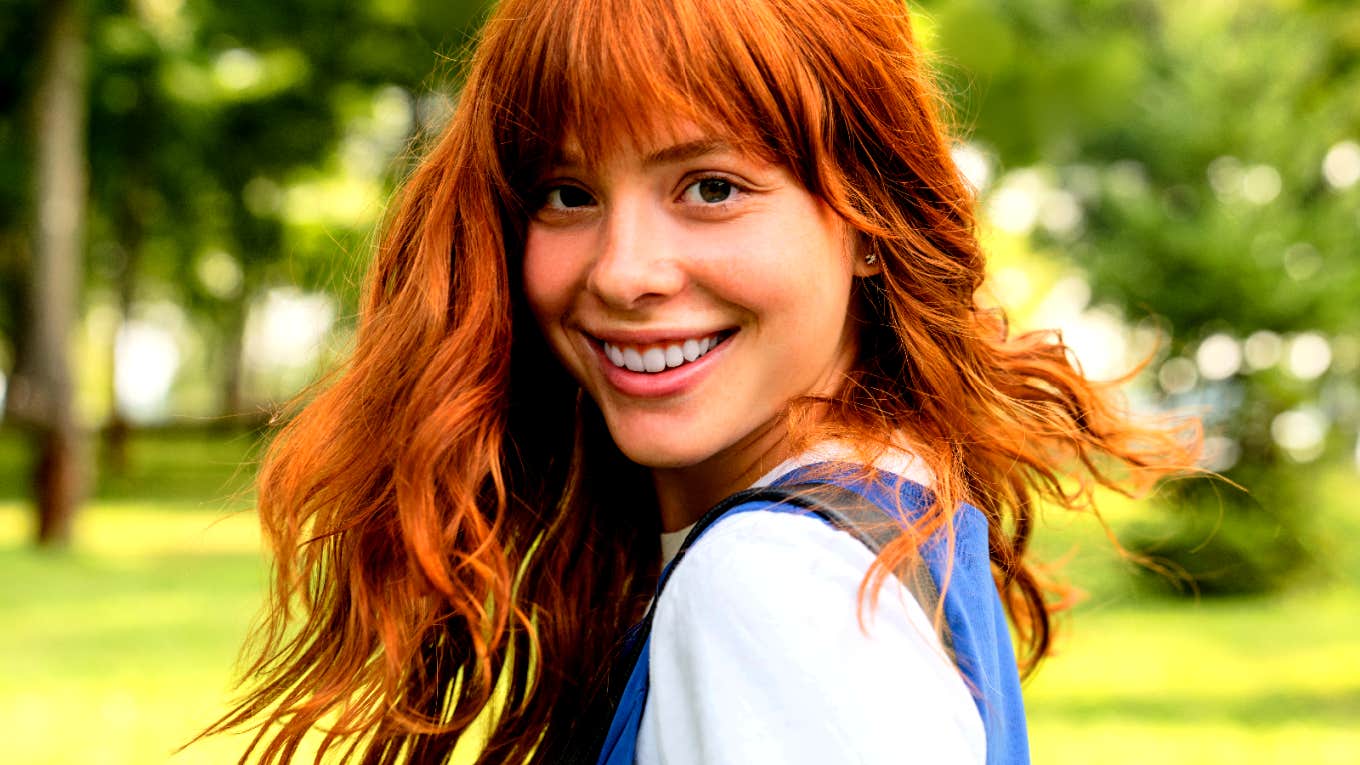 Characteristics Of The Smartest, Most Competent People smiling woman with red hair