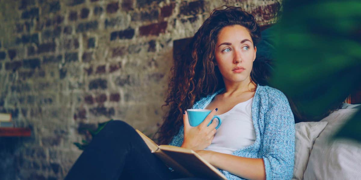 The Big Mistake You're Making That Seriously Affects Your Self-Esteem girl sitting in bed reading a book