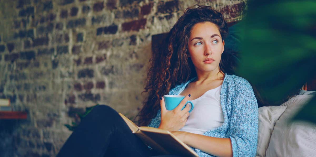 girl sitting in bed reading a book