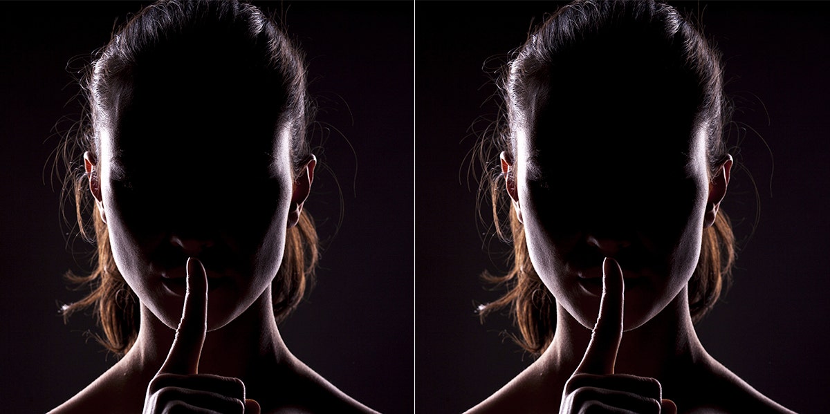 silhouette of a woman shushing