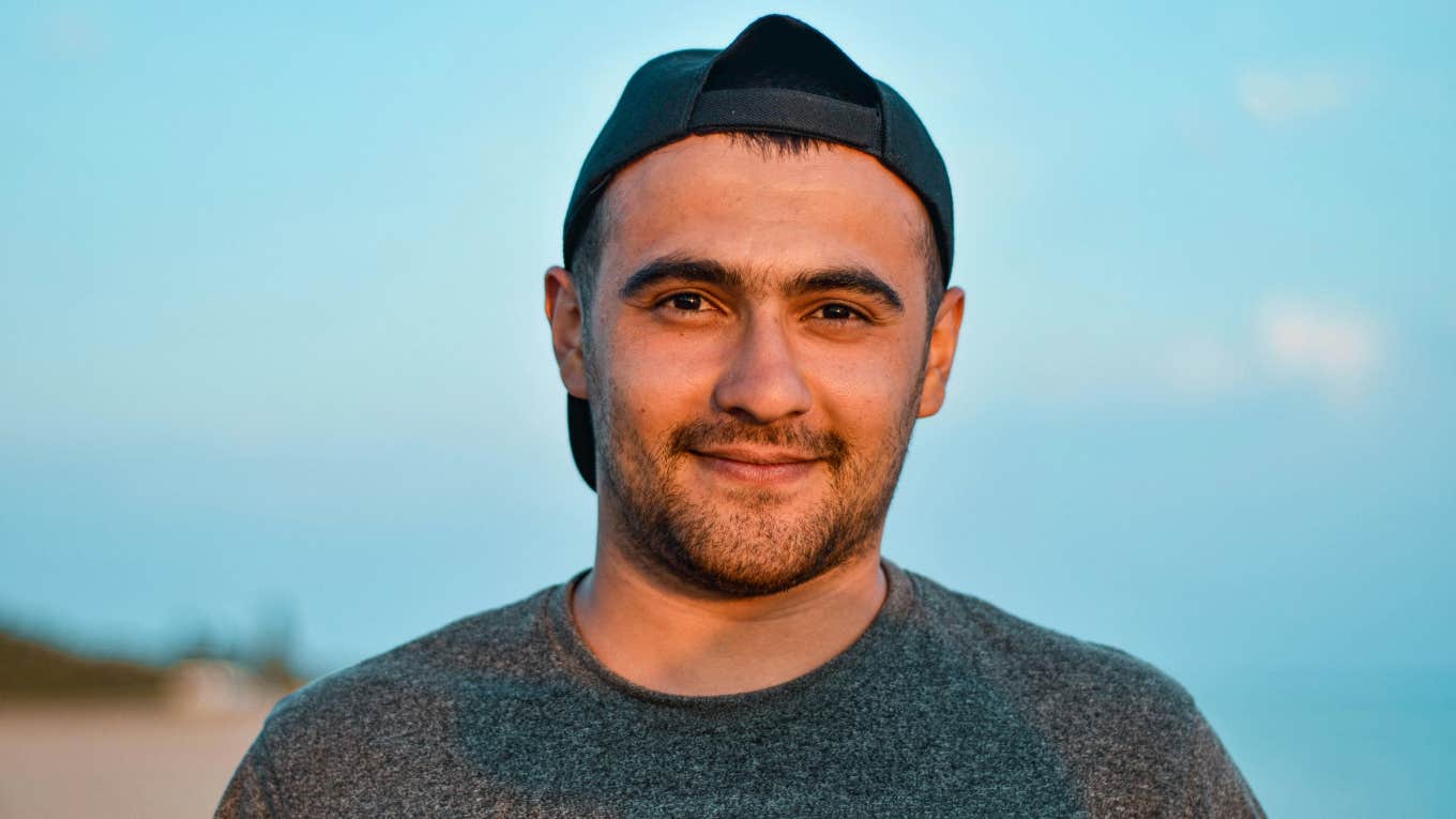 smirking man with hat