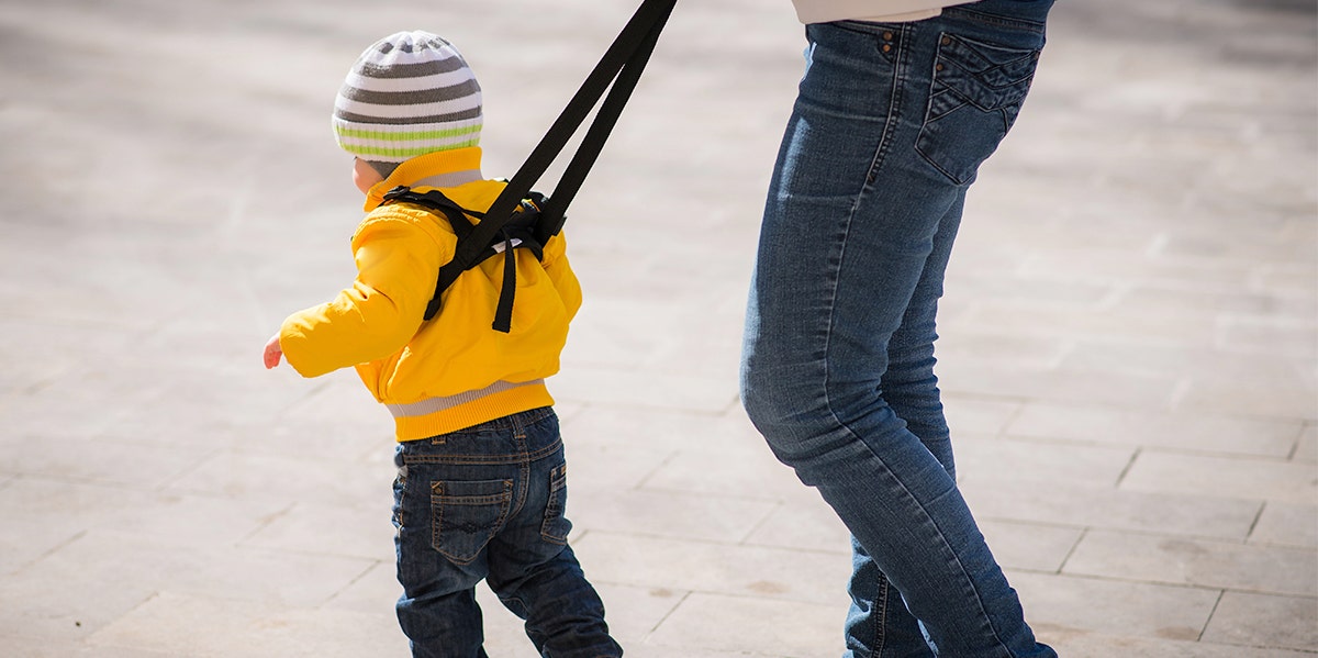If You Walk Your Kid On A Leash, You're Treating Them Like A Dog parent with a child on a leash