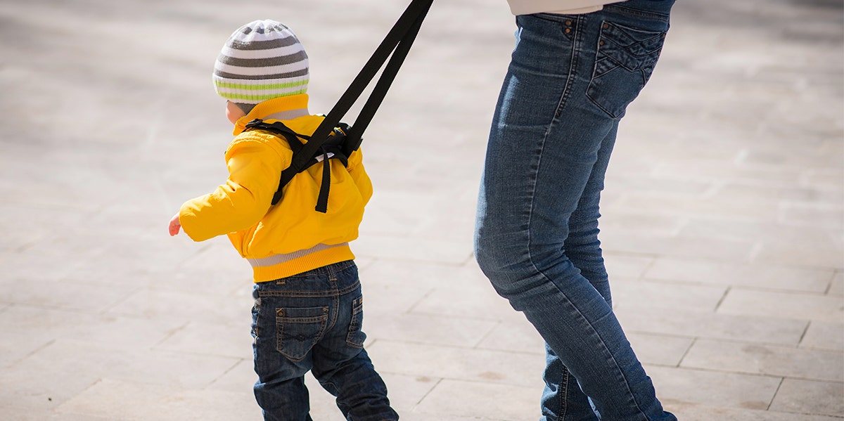 parent with a child on a leash