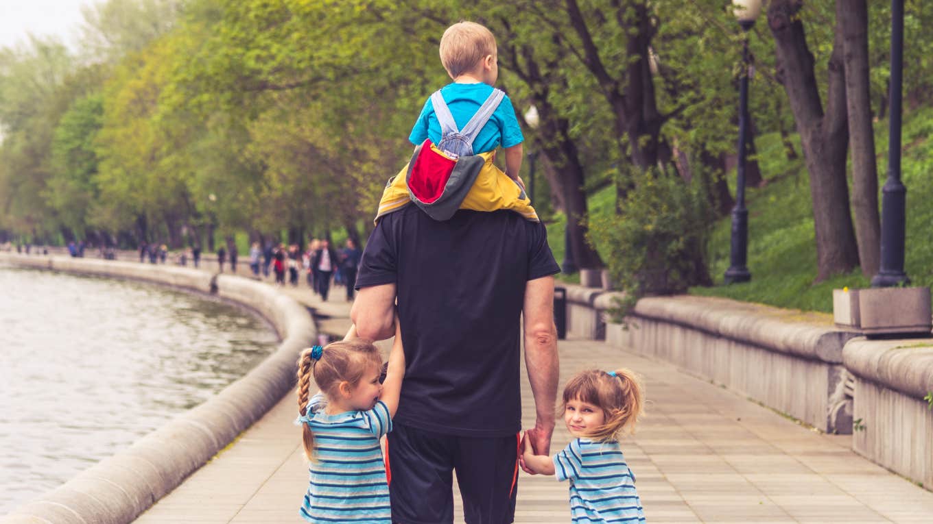 dad with three kids walking