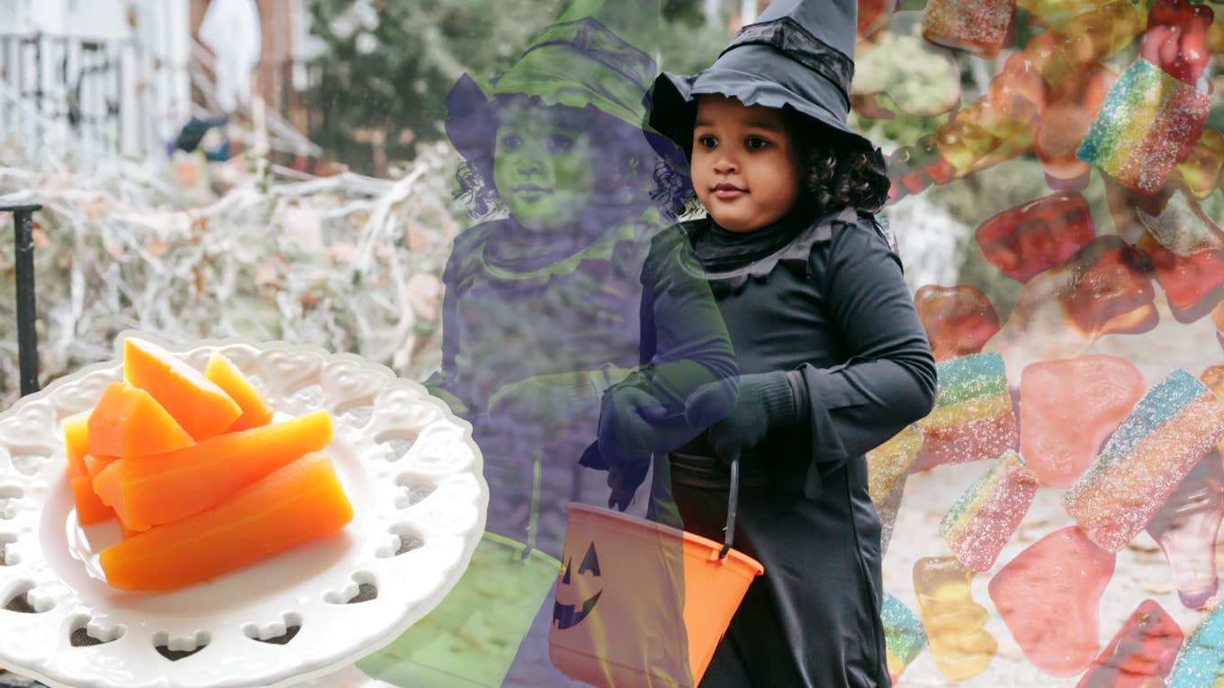 Little girl dressed as a witch, green from the carrots in front of her