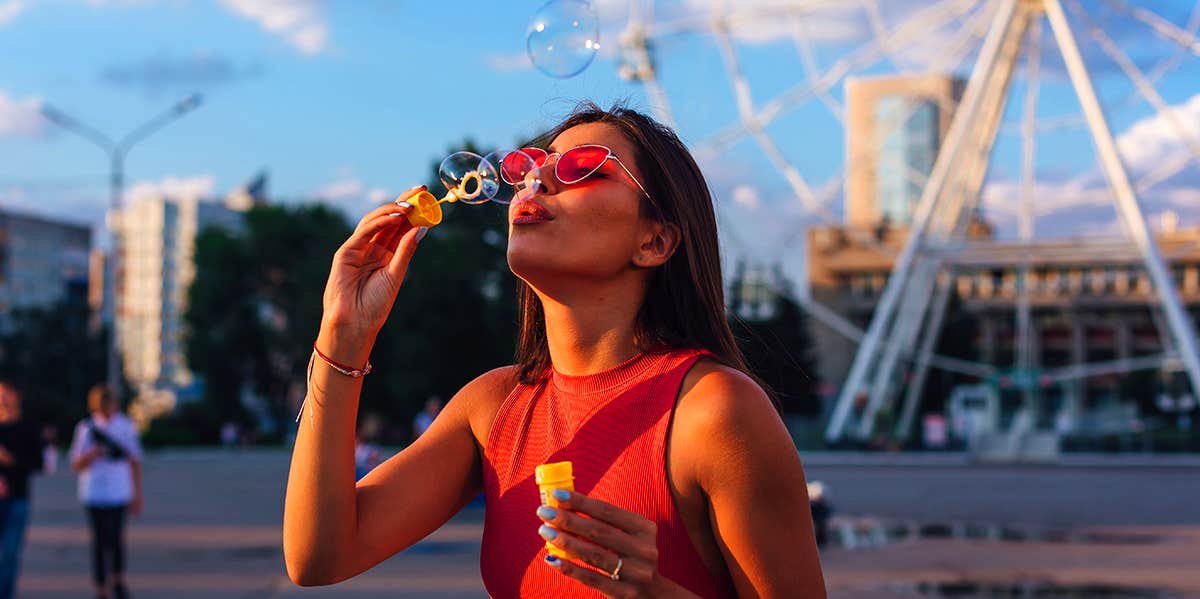 young girl blowing bubbles