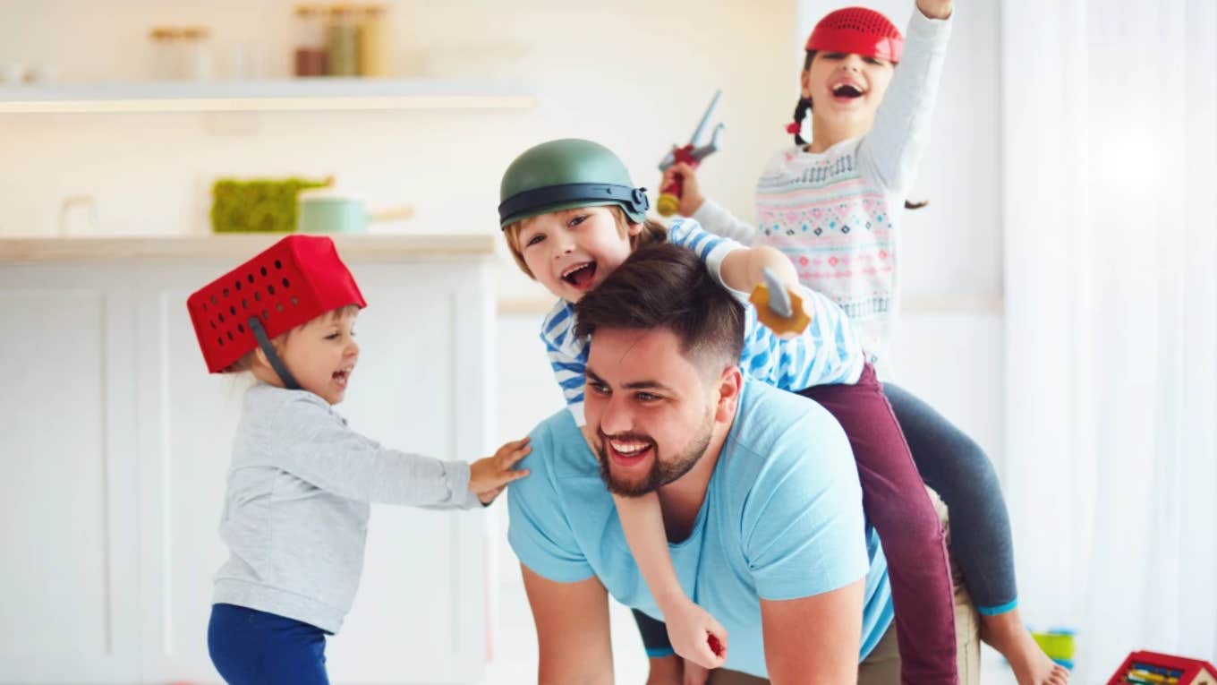 dad playing with three kids