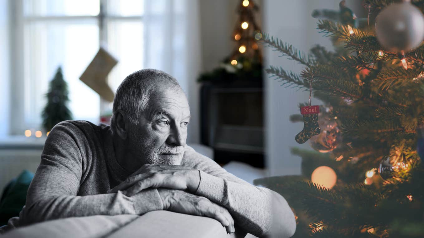 Mature man staring at Christmas tree 