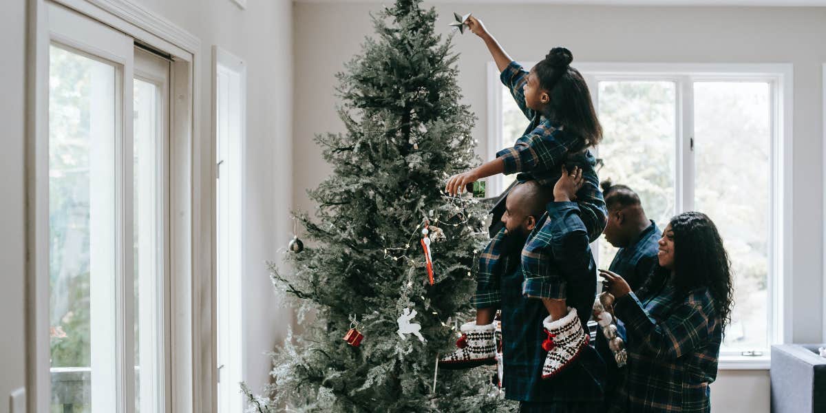 Family decorating Christmas tree