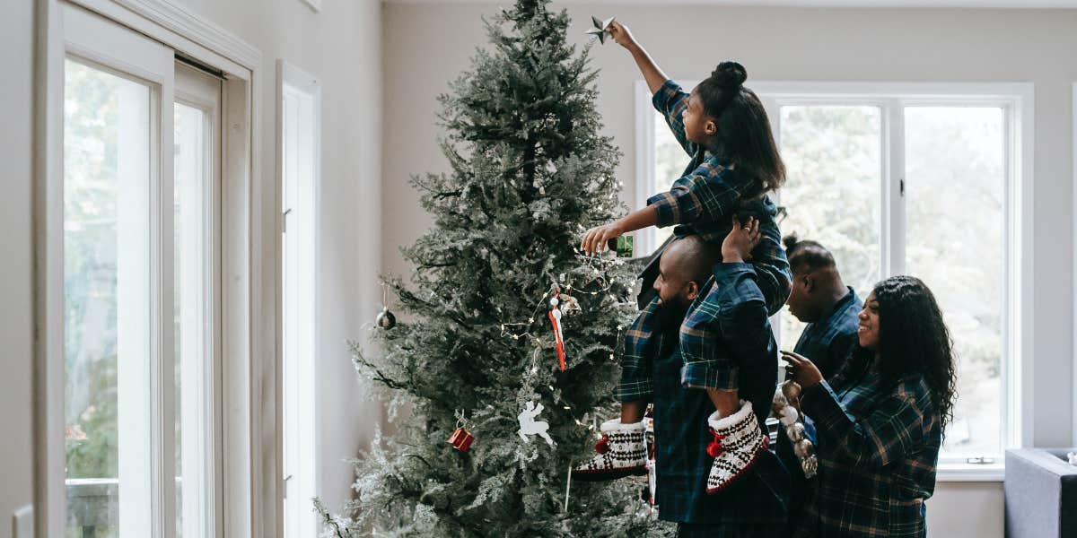 Dad Cancels Christmas To Save Money—& Buys Himself A PS5 Family decorating Christmas tree