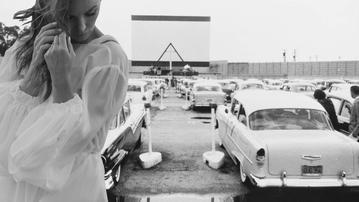 modern woman at a 1950s drive in movie