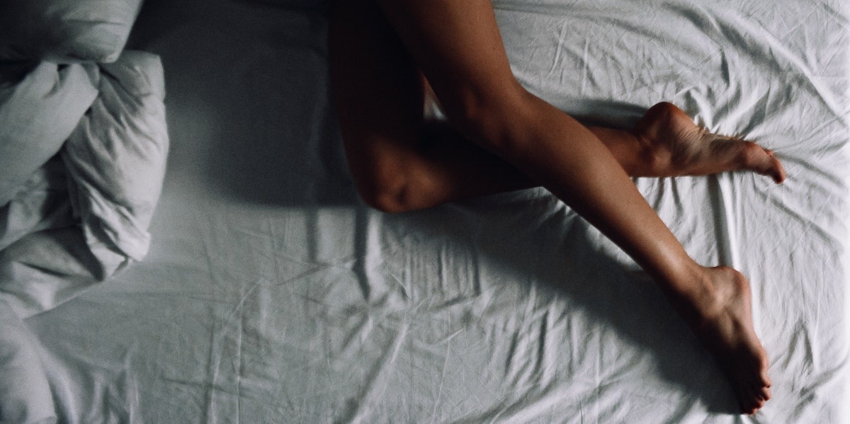 woman's legs on a bed